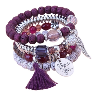 Bohemian multi-layer beaded bracelet with purple tassels, silver wing charms, and crystals