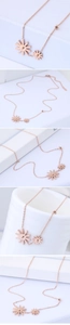 Detail of rose gold double sunflower pendant necklace with delicate link chain