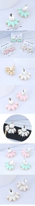 Detailed macro view showing teardrop crystals and floral resin petals on stud earrings