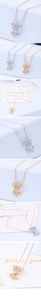 Macro shot of silver and gold sitting dog necklaces with pave-set white cubic zirconia stones