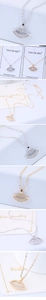 Detailed view of gold and silver lip pendants encrusted with sparkling white rhinestones