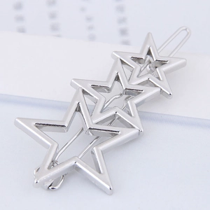 Minimalist silver starfish hair clip with hollow star designs on a clean magazine background