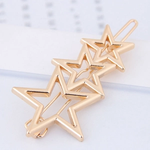 Golden minimalist starfish hair clip with three overlapping stars in metal alloy