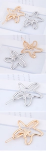 Detailed view of hollowed starfish hair clips in polished gold and silver finishes