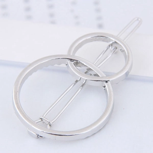 Minimalist silver geometric hair clip with overlapping circular metal design