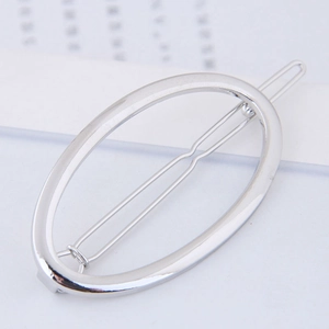 Minimalist silver oval metal hair clip with a polished finish for modern styling