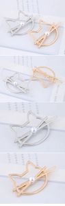 Close-up of cat-shaped metal hair clips in gold and silver with imitation pearl detail
