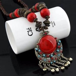 Ethnic bohemian long necklace with red beads and vintage metal bell pendants