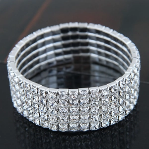 Elegant 5-row crystal rhinestone stretch bracelet with silver base on a mirror surface