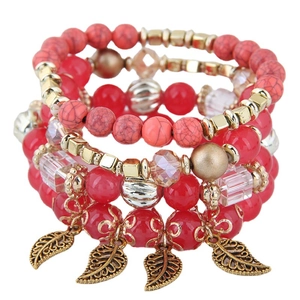 Fashionable red beaded multi-layer bracelet set with golden leaf pendants on white background
