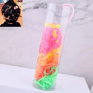 Colorful elastic hair bands for children in a clear cylinder storage container