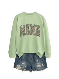 Detail showing ribbed crewneck sweatshirt with camouflage MAMA print and ripped denim shorts