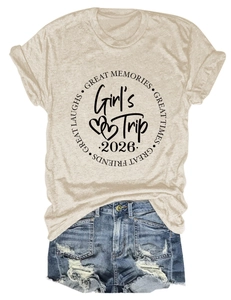 Flat lay of a beige t-shirt with Girl's Trip 2026 print and distressed denim shorts