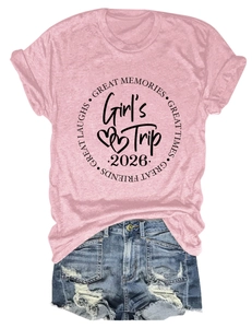 Detailed view of Girl's Trip 2026 lettering on pink t-shirt with ripped denim shorts