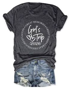 Flat lay of gray Girl's Trip 2026 t-shirt and distressed denim shorts with raw edges