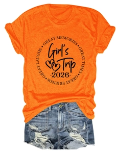 Close-up of orange cotton T-shirt with Girl's Trip 2026 print and ripped denim shorts