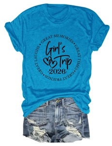 Flat lay of bright blue Girl's Trip 2026 cotton T-shirt with ripped denim shorts