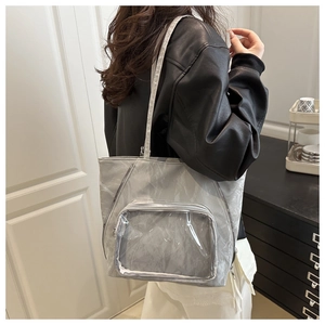 Gray tote bag detail showing textured fabric and a transparent PVC front pocket display