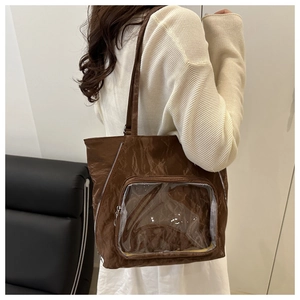 Close-up of brown pleated tote bag with a clear front window for badge display