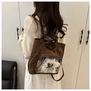 Detailed view of coffee brown tote bag featuring a transparent pocket with lace decor