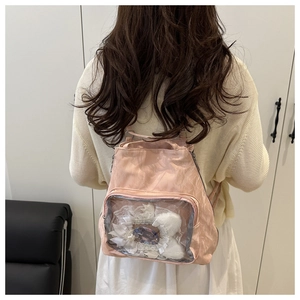 Detail of pink ita bag featuring a large transparent PVC window for personalized display