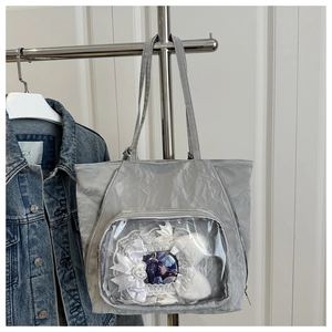 Detail of grey wrinkled texture Ita bag with clear display window and lace bow decoration