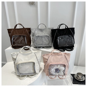 Five assorted colors of large ita bags with transparent windows on a display shelf