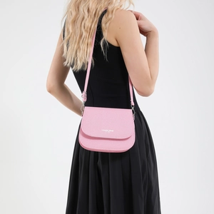 Pink pebbled leather saddle bag with Fashion Trend logo shown on a model