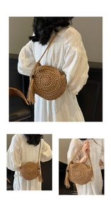Detailed shot of handmade straw bag featuring hollow weave patterns and long tassels
