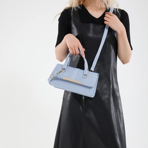 Retro light blue crossbody handbag with gold hardware and textured fabric finish