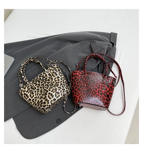 Detail view of leopard print bucket bags with metal studs and detachable shoulder straps