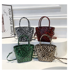 Detailed view of four colorful leopard print bucket bags arranged on minimalist white steps