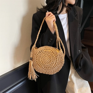 Handmade woven straw shoulder bag with stylish tassels for beach vacations and summer wear