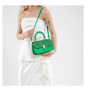 Gros plan du sac à bandoulière à paillettes vert vif avec fermoir doré tournant