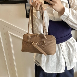 Brown woven bowling bag with golden buckles and dual shoulder straps for women