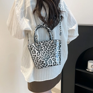 Stylish leopard print bucket bag with adjustable crossbody strap and top handle design
