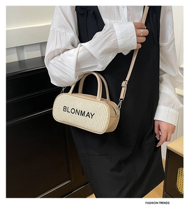 Close-up of contrast woven handbag with leather straps and BLONMAY logo branding