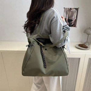 Large capacity army green nylon tote bag for women with drawstring side and stylish charms