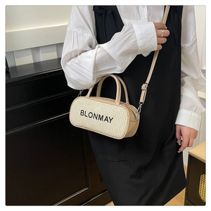 Detail view of woven leather bowling bag with BLONMAY logo shown on a model