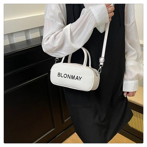 Detailed macro view of minimalist white bucket bag with BLONMAY logo and silver hardware