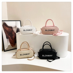 Detailed arrangement of four corduroy mini Boston bags in white, pink, beige, and black