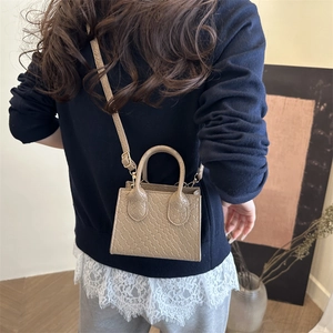 Beige woven texture mini square tote bag shown with model for size reference