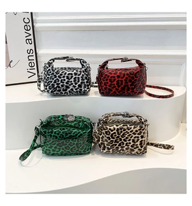 Group shot of leopard print handbags in four colors with metal buckles and shoulder straps