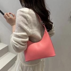 Pink leather hobo bag for women worn by model showing minimalist moon shape style