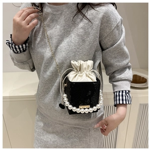 Close-up of black snake pattern leather crossbody bag with white satin drawstring interior