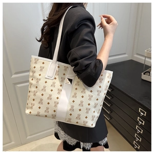 Close-up of litchi texture PU leather tote with cartoon bear patterns and metal buckle
