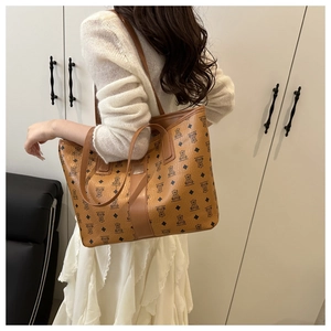 Detail shot of brown tote bag with bear and diamond patterns for shoulder carry