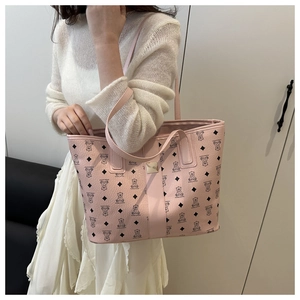 Close-up of pink tote bag with bear print, lychee texture, and gold metal hardware detail