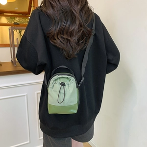 Minimalist green drawstring crossbody bag for outdoor hiking and casual daily use