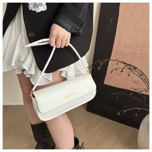 Detail of white leather baguette bag with FASHION & BAGS golden letter logo print